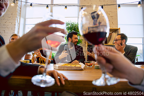 Image of Happy co-workers celebrating while company party and corporate event