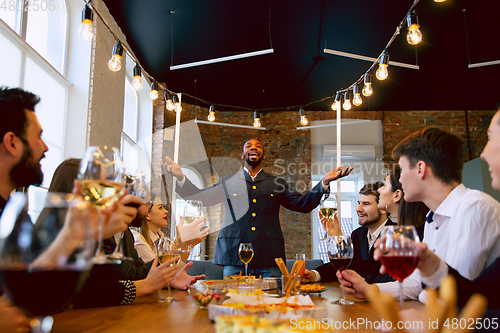 Image of Happy co-workers celebrating while company party and corporate event