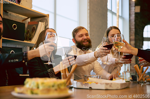 Image of Happy co-workers celebrating while company party and corporate event