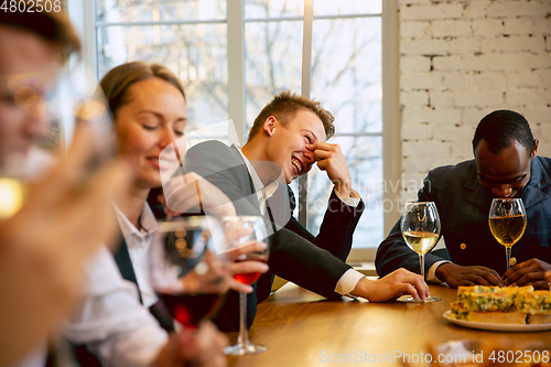 Image of Happy co-workers celebrating while company party and corporate event