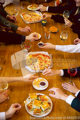 Image of Happy co-workers celebrating while company party and corporate event