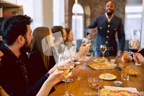 Image of Happy co-workers celebrating while company party and corporate event