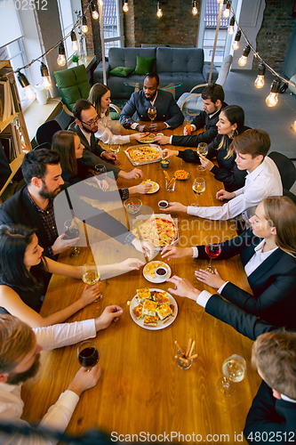 Image of Happy co-workers celebrating while company party and corporate event