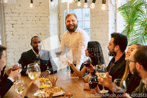 Image of Happy co-workers celebrating while company party and corporate event