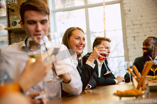 Image of Happy co-workers celebrating while company party and corporate event