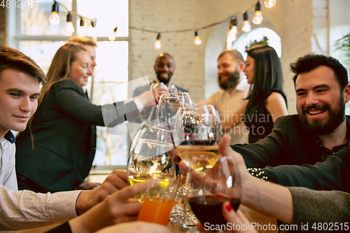 Image of Happy co-workers celebrating while company party and corporate event