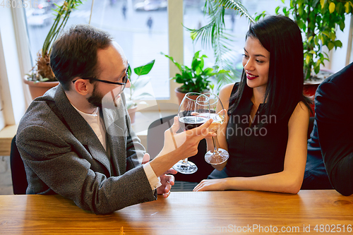 Image of Happy co-workers celebrating while company party and corporate event