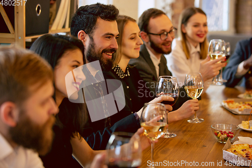 Image of Happy co-workers celebrating while company party and corporate event