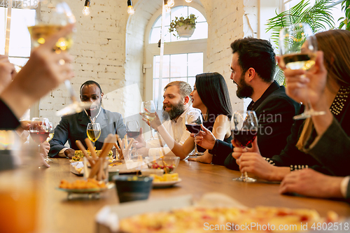 Image of Happy co-workers celebrating while company party and corporate event