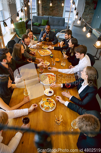 Image of Happy co-workers celebrating while company party and corporate event