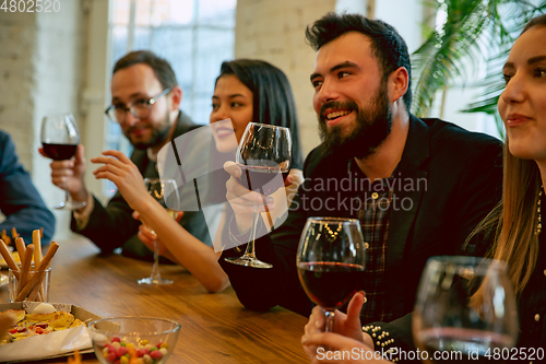 Image of Happy co-workers celebrating while company party and corporate event