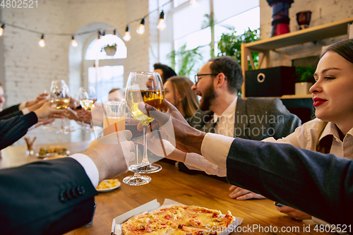 Image of Happy co-workers celebrating while company party and corporate event