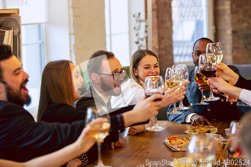 Image of Happy co-workers celebrating while company party and corporate event