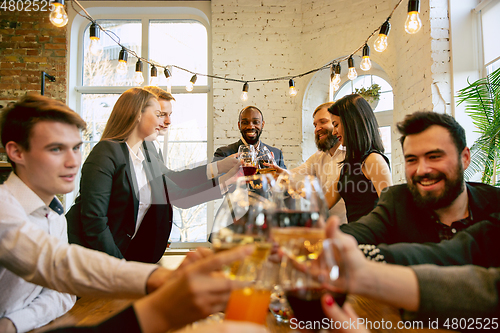 Image of Happy co-workers celebrating while company party and corporate event