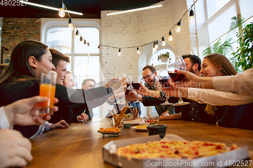 Image of Happy co-workers celebrating while company party and corporate event