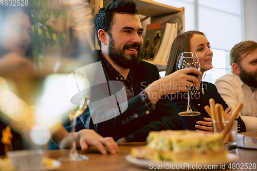 Image of Happy co-workers celebrating while company party and corporate event