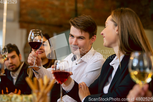 Image of Happy co-workers celebrating while company party and corporate event