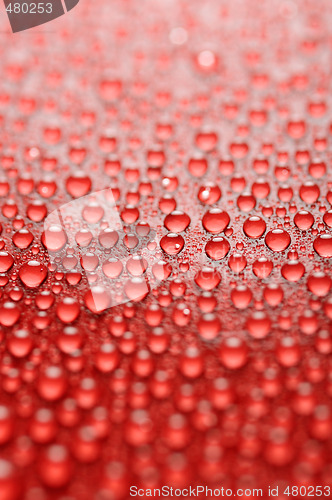 Image of water drops on red background