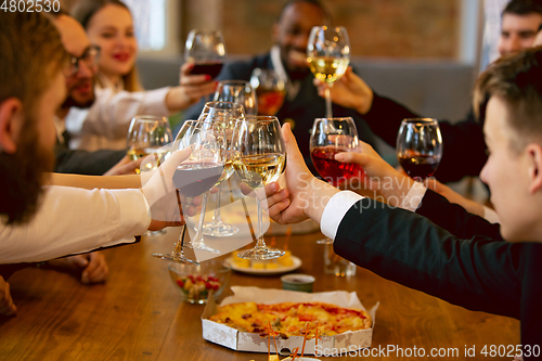 Image of Happy co-workers celebrating while company party and corporate event