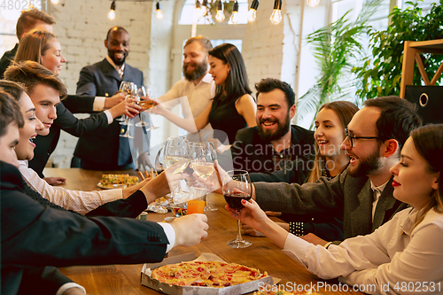 Image of Happy co-workers celebrating while company party and corporate event