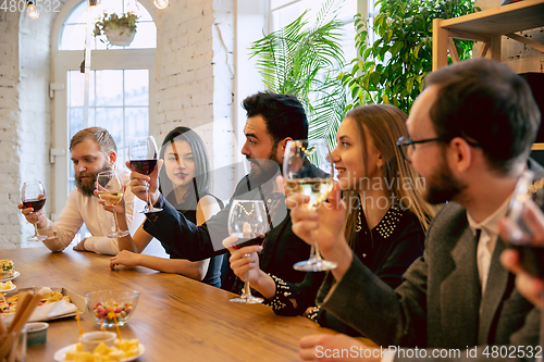 Image of Happy co-workers celebrating while company party and corporate event