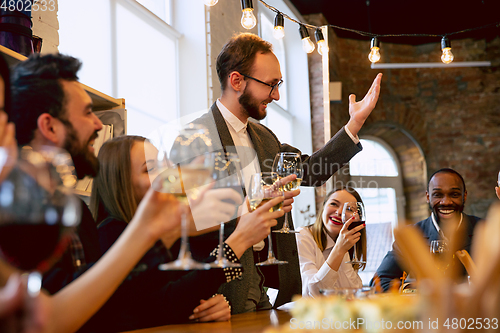 Image of Happy co-workers celebrating while company party and corporate event