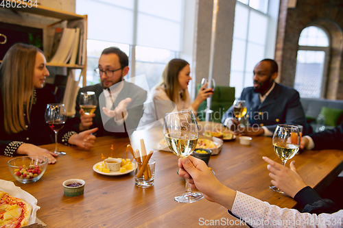 Image of Happy co-workers celebrating while company party and corporate event