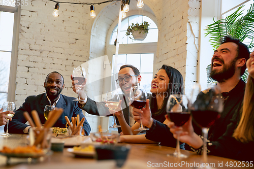 Image of Happy co-workers celebrating while company party and corporate event