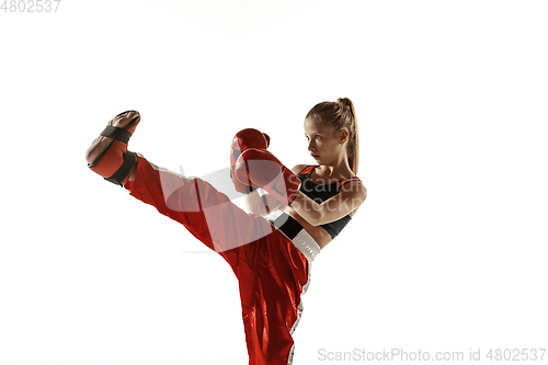 Image of Young female kickboxing fighter training isolated on white background