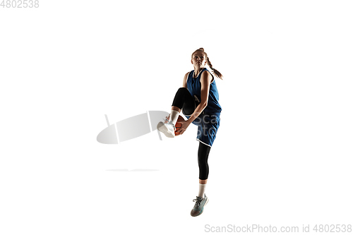 Image of Young caucasian female basketball player against white studio background