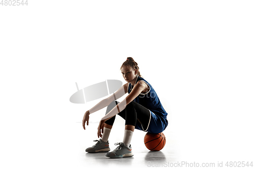 Image of Young caucasian female basketball player against white studio background