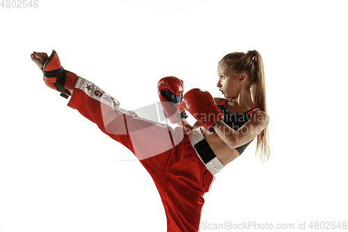 Image of Young female kickboxing fighter training isolated on white background