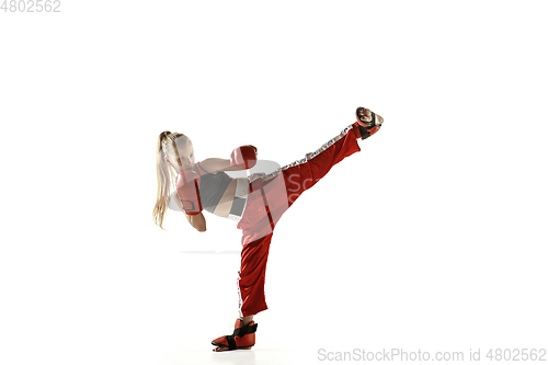 Image of Young female kickboxing fighter training isolated on white background