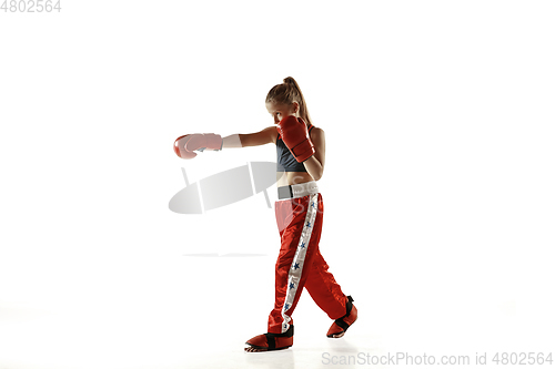 Image of Young female kickboxing fighter training isolated on white background