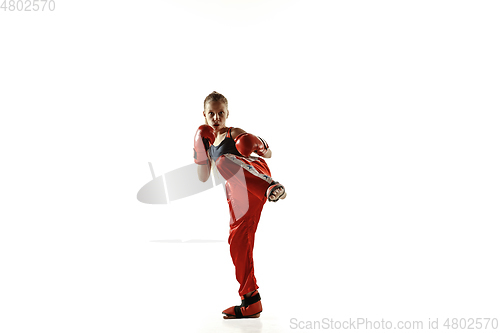 Image of Young female kickboxing fighter training isolated on white background