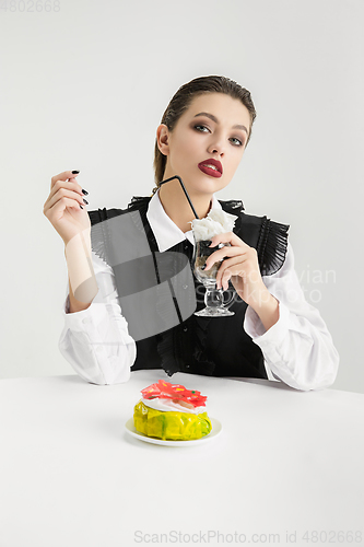 Image of We are what we eat. Woman\'s eating plastic food, eco concept