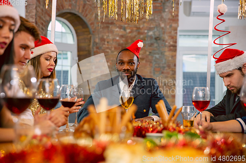 Image of Happy co-workers celebrating while company party for New Year and Christmas