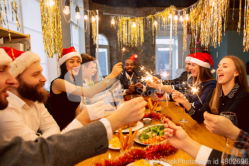 Image of Happy co-workers celebrating while company party for New Year and Christmas