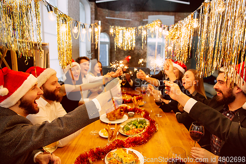 Image of Happy co-workers celebrating while company party for New Year and Christmas