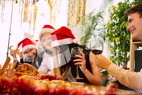 Image of Happy co-workers celebrating while company party for New Year and Christmas