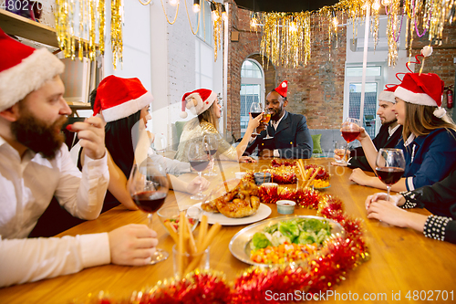 Image of Happy co-workers celebrating while company party for New Year and Christmas