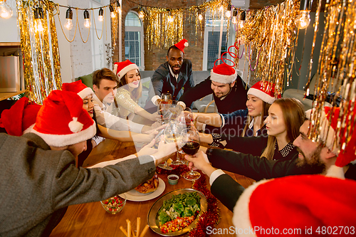 Image of Happy co-workers celebrating while company party for New Year and Christmas