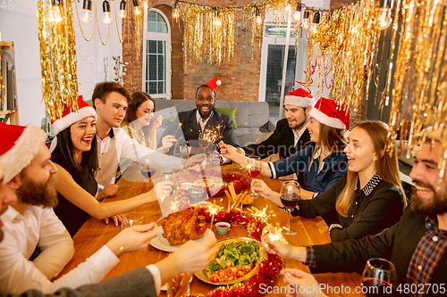 Image of Happy co-workers celebrating while company party for New Year and Christmas