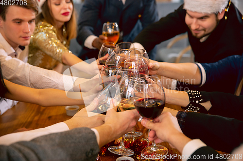 Image of Happy co-workers celebrating while company party for New Year and Christmas