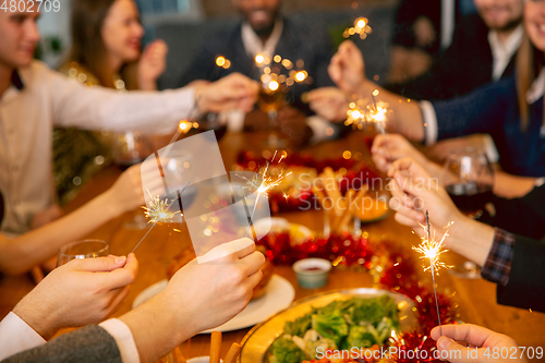 Image of Happy co-workers celebrating while company party for New Year and Christmas