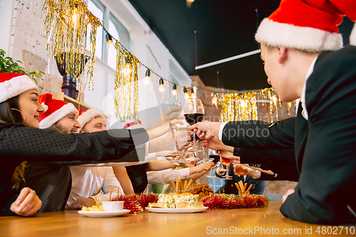 Image of Happy co-workers celebrating while company party for New Year and Christmas