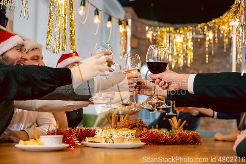 Image of Happy co-workers celebrating while company party for New Year and Christmas