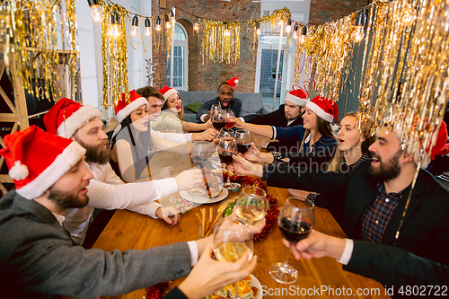 Image of Happy co-workers celebrating while company party for New Year and Christmas