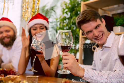 Image of Happy co-workers celebrating while company party for New Year and Christmas