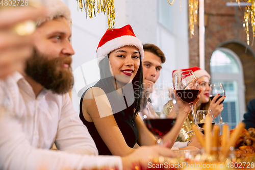 Image of Happy co-workers celebrating while company party for New Year and Christmas